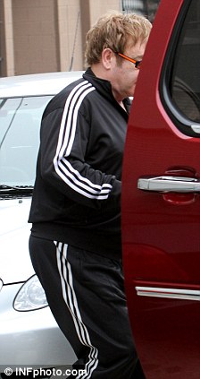 Circle of life: Sir Elton was holding a CD in his right hand as he left the studio and into a waiting car